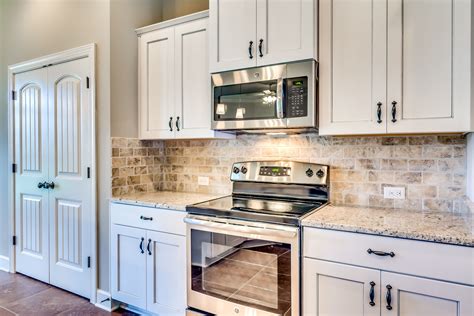 white kitchen with stainless steel countertops